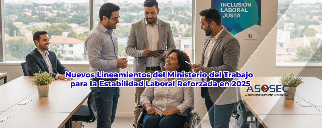 Grupo de profesionales en una oficina luminosa, incluyendo una mujer con discapacidad en silla de ruedas, junto a un cartel de "Inclusión Laboral Justa" del Ministerio del Trabajo.